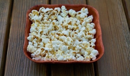 Food on a wooden cutting board, with Popcorn
